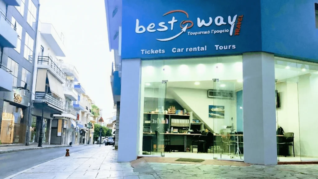 Exterior view of Best Way Travel car rental office located at Idomeneos 37 in Heraklion city center with glass storefront